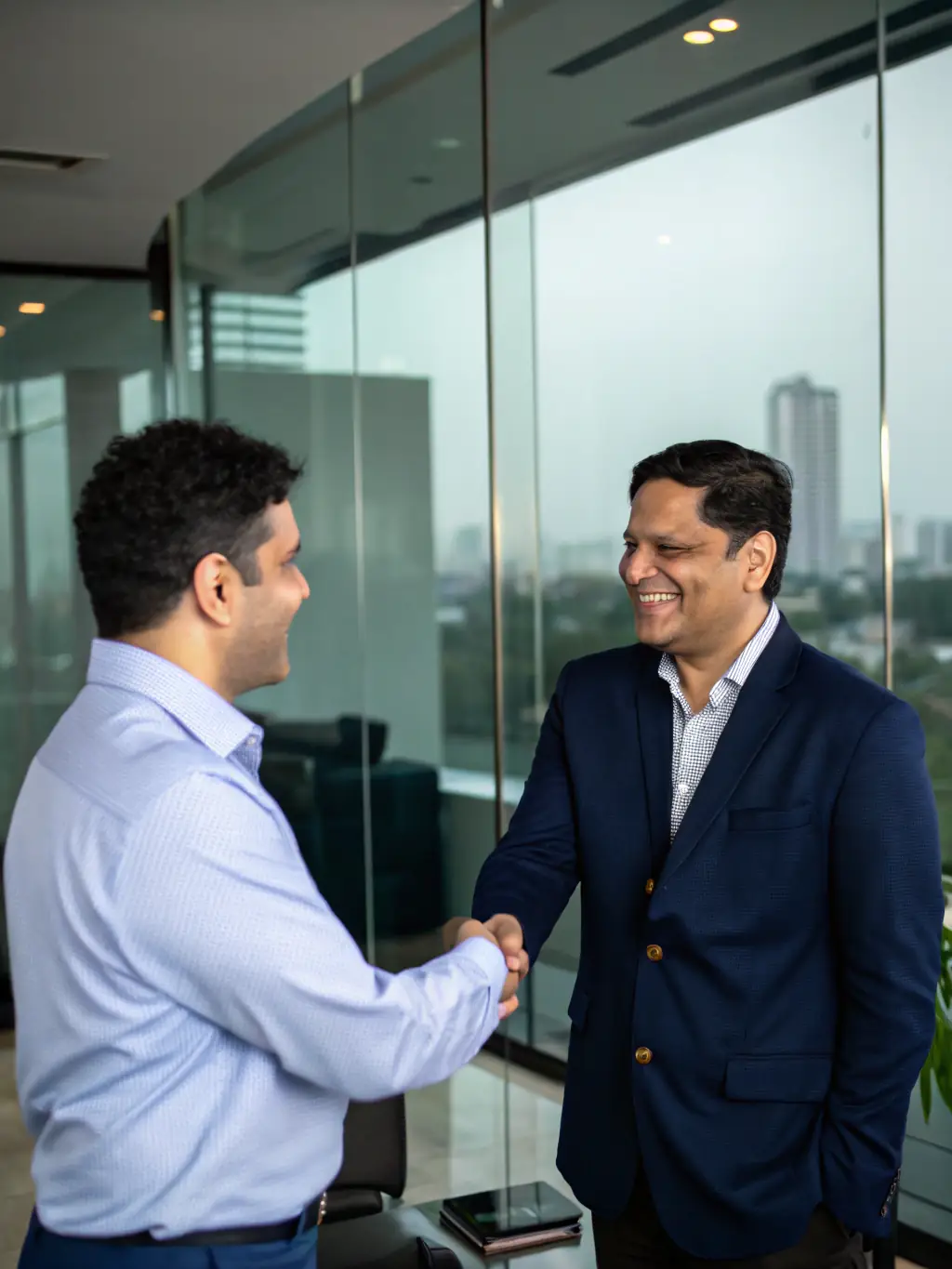 A business owner shaking hands with an advisor in a Delhi office, representing business financial consulting and growth strategies.